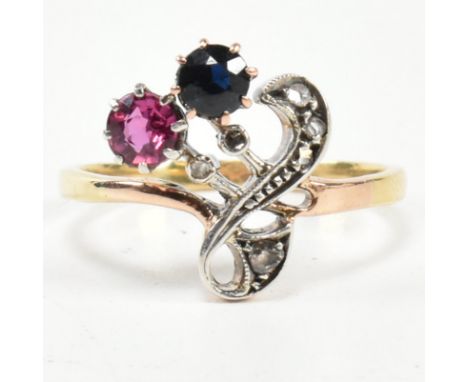 An Art Nouveau ruby, sapphire and diamond ring. The ring having a round mixed cut ruby and sapphire with diamond chip accents