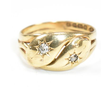 An Edwardian hallmarked 18ct gold and diamond twin snake ring. The ring in the form of two coiled snakes having a star set ol