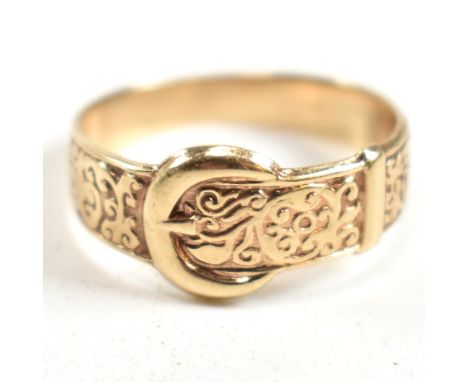 A hallmarked 9ct gold engraved buckle ring. The ring having a belt buckle design with scrolling decoration to tapered shank. 
