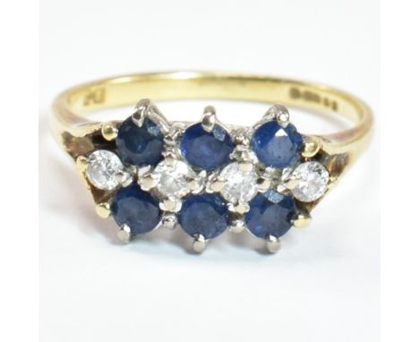 A hallmarked 18ct gold, sapphire and diamond three layer ring. The ring set with two rows of three round cut sapphires with a