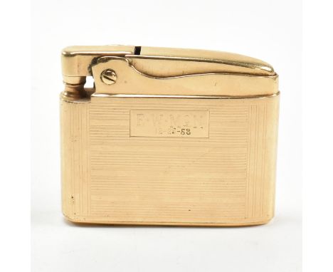 A gold Ronson Adonis pocket lighter stamped 14k.&nbsp;The 14ct gold pocket lighter having an all-over engine turned design wi