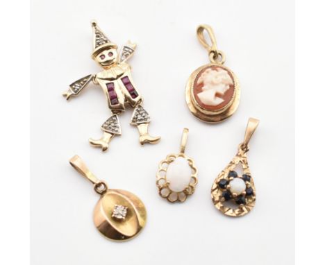 Five 9ct gold and gem set necklace pendants. The pendants to include a 9ct gold, ruby and diamond articulating clown pendant,