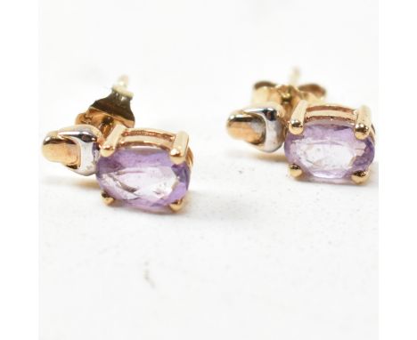 A pair of 9ct gold and amethyst stud earrings. The 9ct gold stud earrings having oval cut amethysts set in a two-tone yellow 