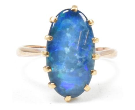 A 9ct gold opal triplet ring. The ring set with an oval opal claw mounted opal triplet to tapering band. Marked 9ct. Weight 2