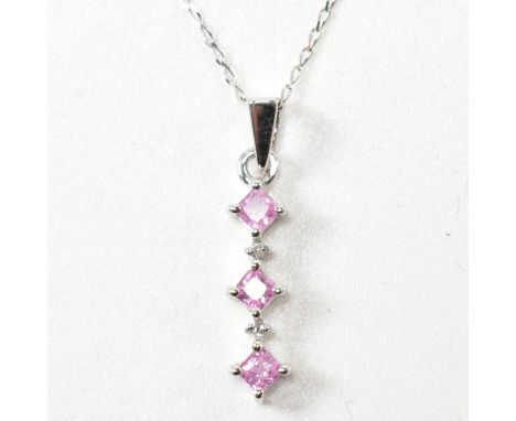 A hallmarked 9ct white gold, pink sapphire and diamond pendant necklace. The pendant having three princess cut pink sapphires