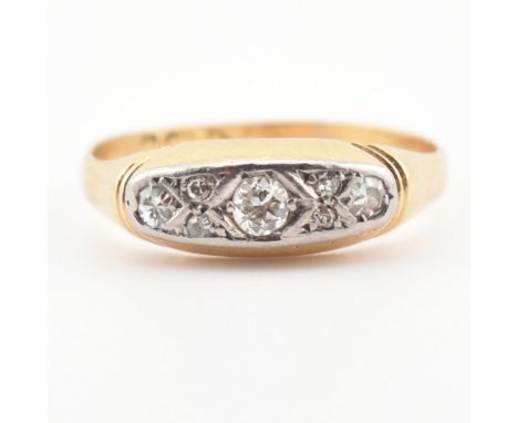 A cased hallmarked 18ct gold and diamond ring. The ring set with three graduating round cut diamonds with four diamond accent
