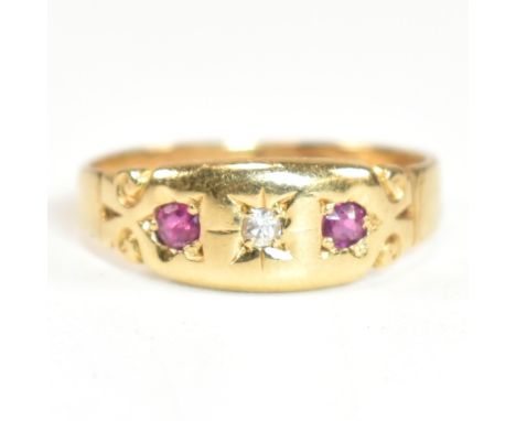 A Victorian hallmarked 18ct gold, ruby and diamond dome ring. The three stone gypsy style ring having a central round cut sta