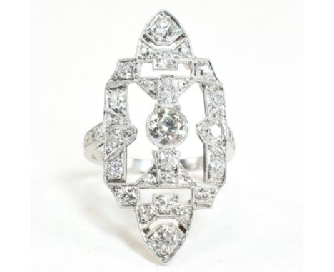 A platinum and diamond panel ring. The ring having a large diamond set pierced panel head.&nbsp;Estimated weight of principal