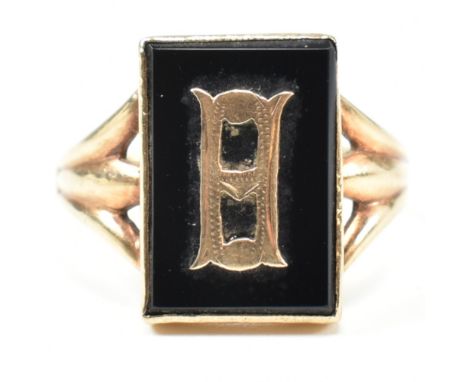 A 9ct gold and onyx Art Deco initial signet ring. The 9ct gold gentleman's signet ring having a rectangular black onyx set ri