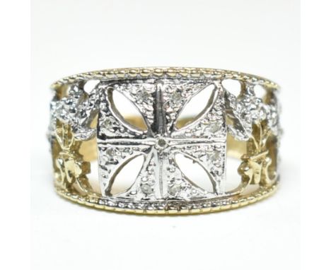 A hallmarked 9ct gold and diamond Maltese cross ring. The pierced band ring having a central white gold Maltese cross nine il