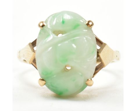 A hallmarked 9ct gold and carved jade dress ring. Hallmarked for Birmingham. Size L.5. Weighs 3.3g. All weights, measurements