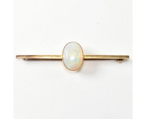 An early 20th century 15ct gold and opal brooch pin. The brooch set with an oval opal cabochon to bar mount having hinged pin