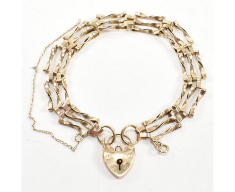 A hallmarked 9ct gold twisted gate link bracelet with heart padlock clasp. The 9ct gold gate link bracelet having a hallmarke
