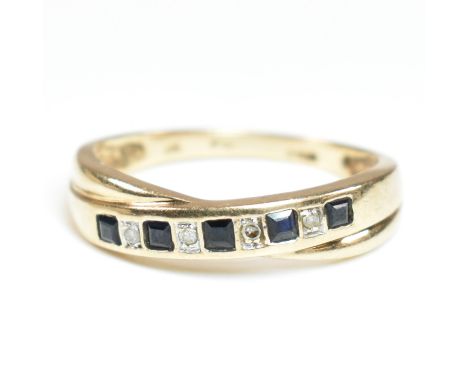 A hallmarked 9ct gold, diamond and sapphire ring. The ring having a single row of five princess cut sapphires interspersed by