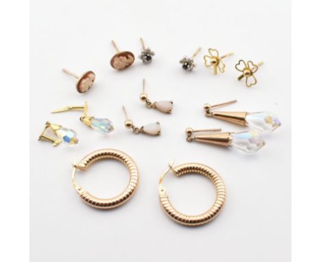 A collection of 9ct gold and gem set earrings. The lot to include a pair of 9ct gold hoop earrings, marked 375 to hinge faste