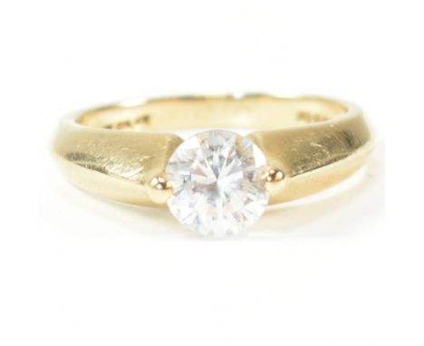 A hallmarked 14ct gold and CZ solitaire ring. The ring set with a single round cut CZ with pinched shoulders to tapered shank