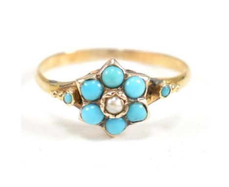 An 18ct gold, turquoise and seed pearl cluster ring. The ring having a central seed pearl surrounded by a a halo of six round