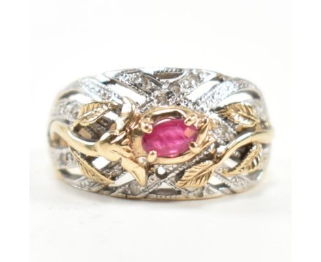 A hallmarked 9ct gold, ruby and diamond ring. The ring having a central four claw set east-west oval cut ruby set on a yellow