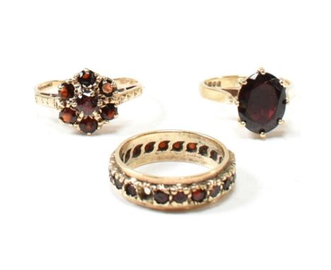 Three 9ct yellow gold and garnet rings. The rings to include a hallmarked 9ct gold and oval cut garnet ring, hallmarked for B