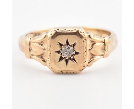 A hallmarked 9ct gold and diamond signet ring. The ring having a star set old cut diamond to acanthus shoulders to plain shan