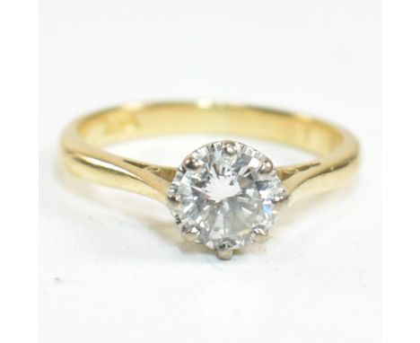 A hallmarked 18ct gold and diamond solitaire ring. The 18ct gold ring set with a single illusion set round cut white stone to