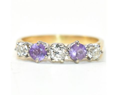 An 18ct gold, amethyst and diamond five stone ring. The ring having three six claw set round cut diamonds interspersed by two