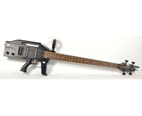 Contemporary late 20th / 21st century laurel machine gun bass guitar. Featuring ebonised wood frame in the shape of a machine