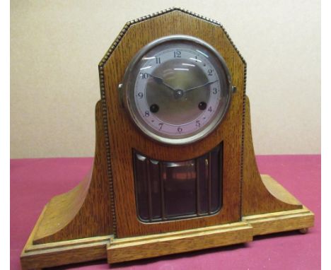 Golden oak cased mantle clock two tone brass bezel enclosing brass dial and applied silvered chapter ring, visible pendulum K