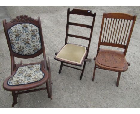 Early 20th C stick back folding chair with pierced laminate seat, similar ladderback folding chair with upholstered seat and 