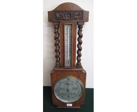1930's oak compensated aneroid barometer and thermometer with silvered dials and barley twist turned decoration H70cm 