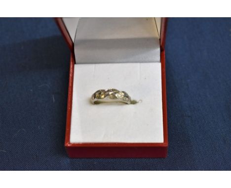 A white gold and diamond twist set ring