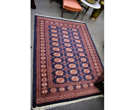 A blue & red ground patterned rug 5ft 8in x 4ft 2in.