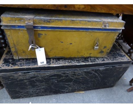 A large black metal trunk and a small tan Egyptian Army metal trunk (2)