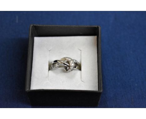 An 18ct white gold and diamond swirl set ring