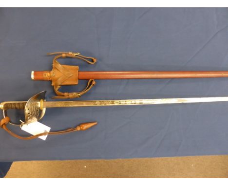 A Officers dress sword with etched blade 'GR ' cypher to guard in leather covered scabbard.