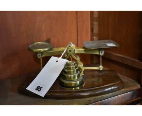 A set of brass & wood postal scales with nested weight set