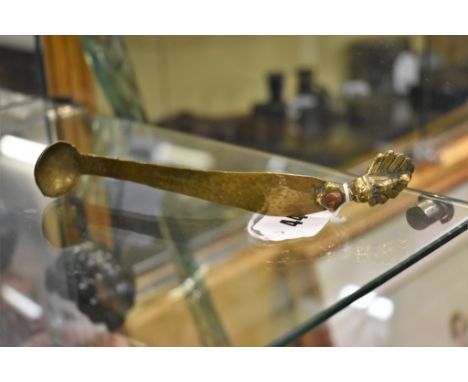 A 19th century Indian brass spice ladle hand hammered stem with cast peacock finial, tapering to a small bowl, 7in. (17.8cm.)