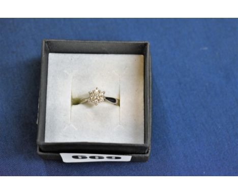A palladium and diamond floral cluster ring