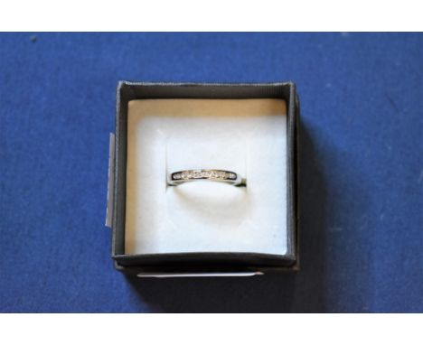 A 9ct white gold and diamond channel set half eternity ring