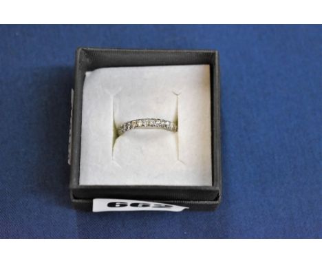 An 18ct white gold and diamond half eternity ring