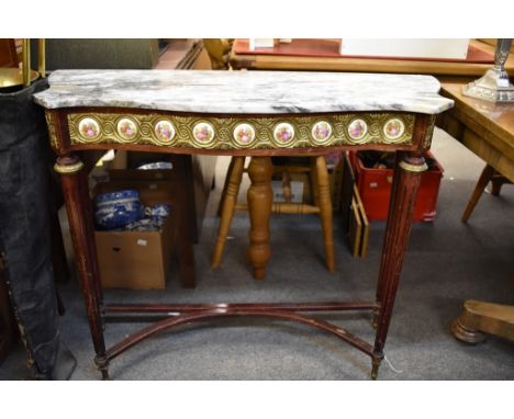 A mid-20th century Empire style occasional table in dark stained mahogany, with circular marble top over a frieze with gilt m