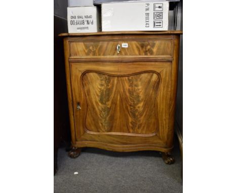 A late 19th century mahogany cabinet possibly French, serpentine front with single drawer above cupboard with centralised con