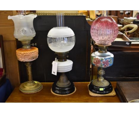 A antique milk glass oil lamp together with two further oil lamps. (3)