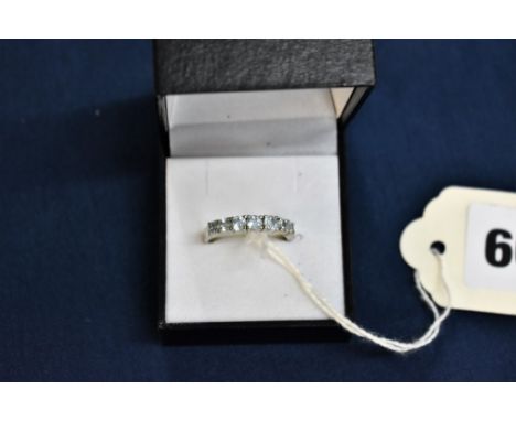 A 14ct gold ladies ring with seven blue topaz gemstones.