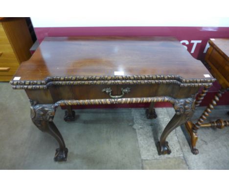 A Chippendale Revival carved mahogany fold over games table 