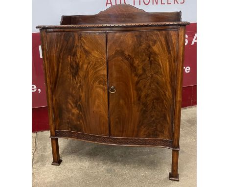 An Edward VII Chippendale Revival mahogany serpentine two door side cabinet 