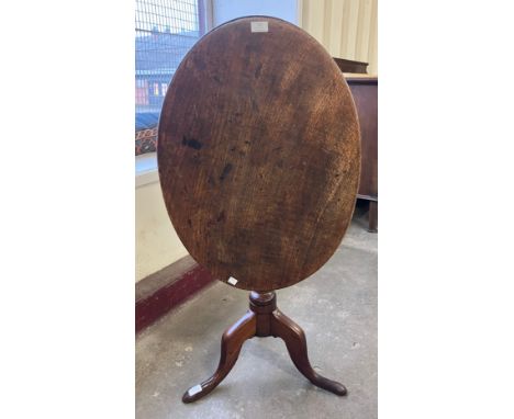A George III oak oval tilt top tripod tea table 