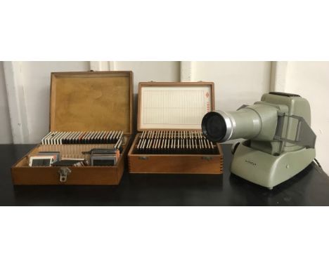 An Aldis slide projector and two boxes of photographic slides 
