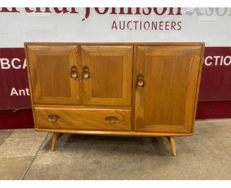 An Ercol Blonde elm and beech Windsor sideboard 