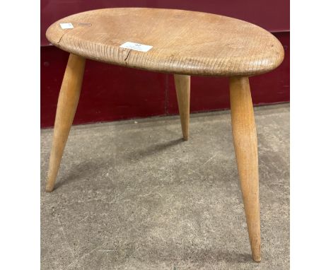 An Ercol Blonde elm and beech pebble occasional table 
